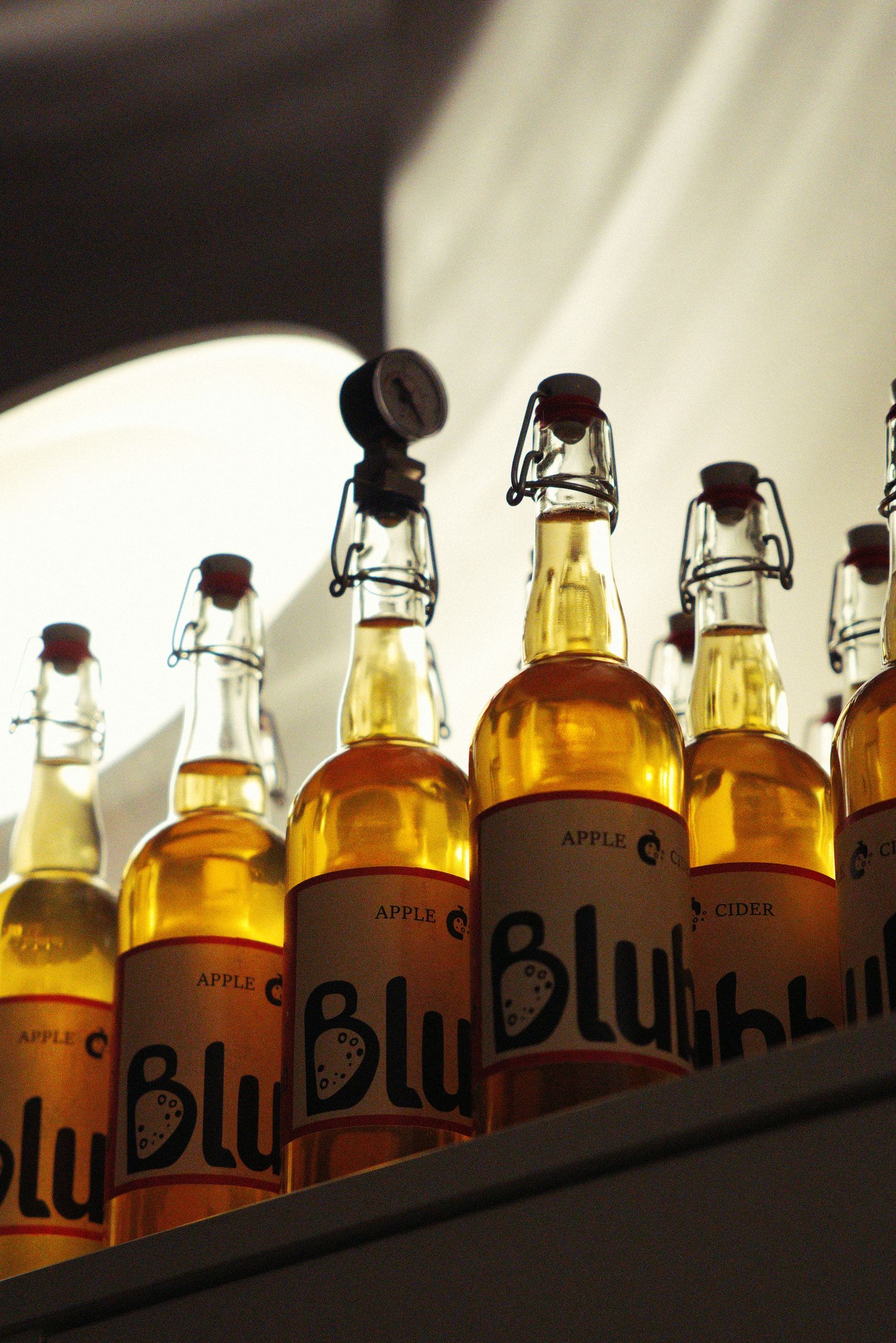 Blubb — backlit apple cider bottles on a shelf