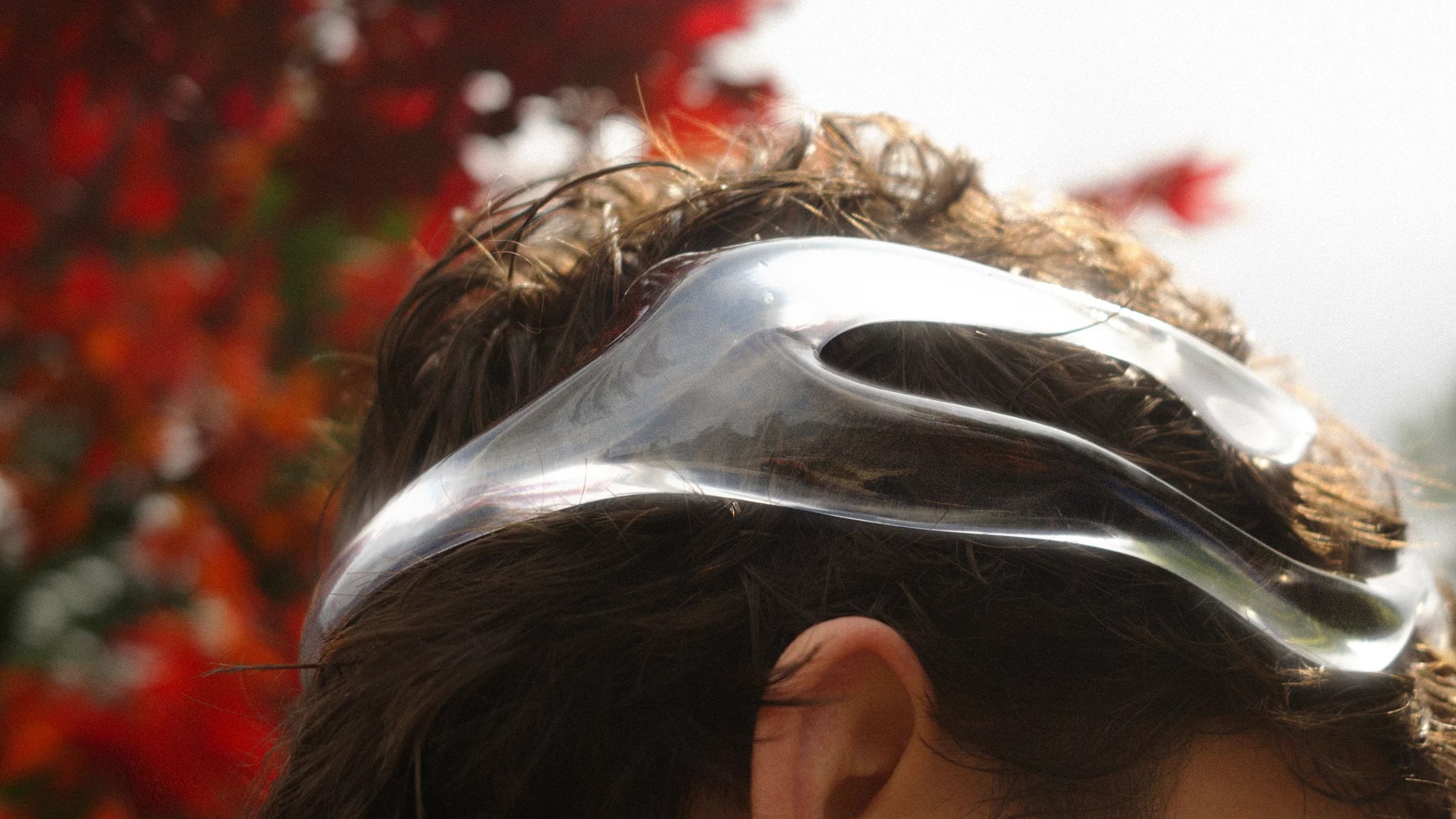The Mourning Crown worn from behind, red autumn leaves in the background
