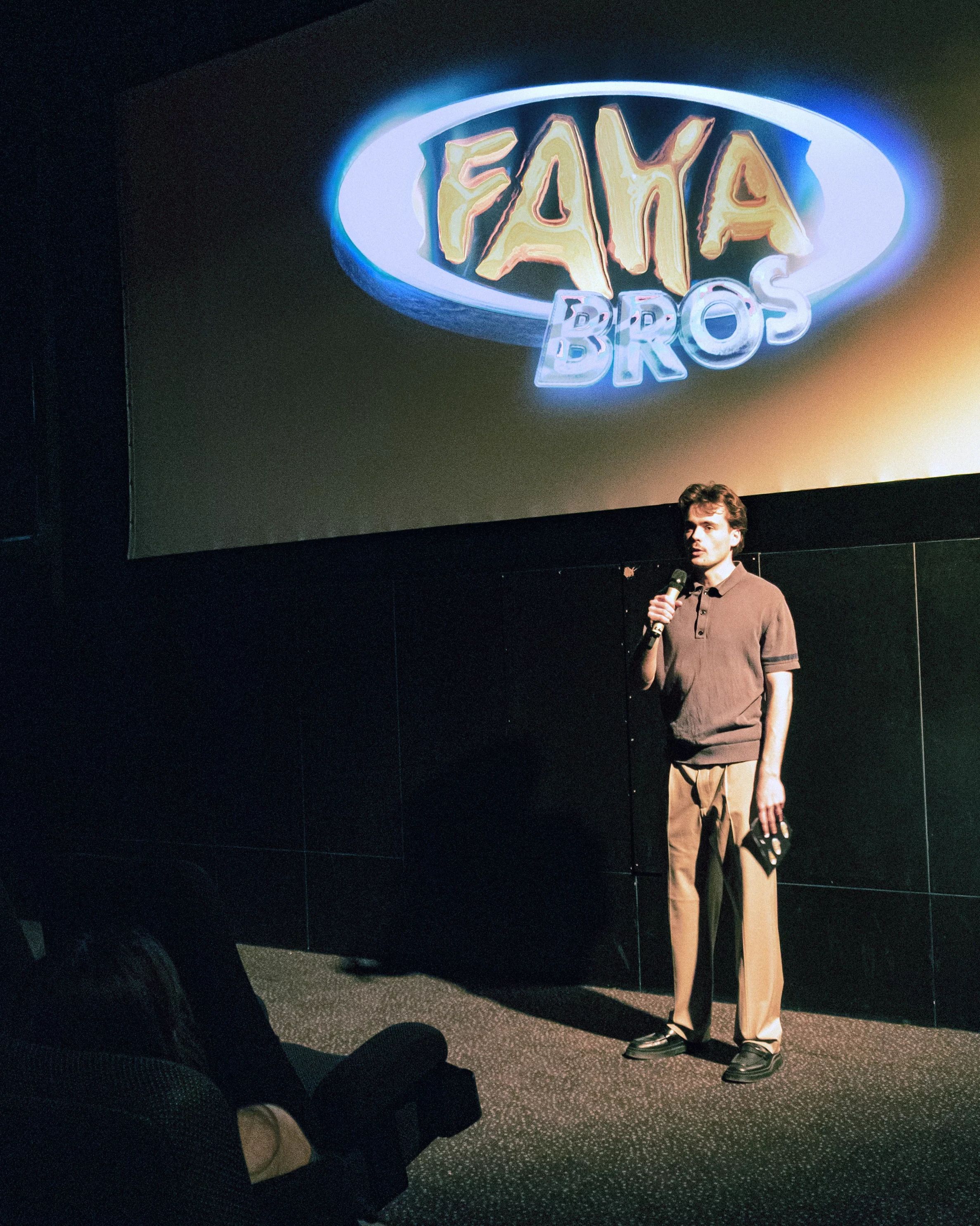 Johann Kraus introducing the premiere beneath the Faka Bros logo
