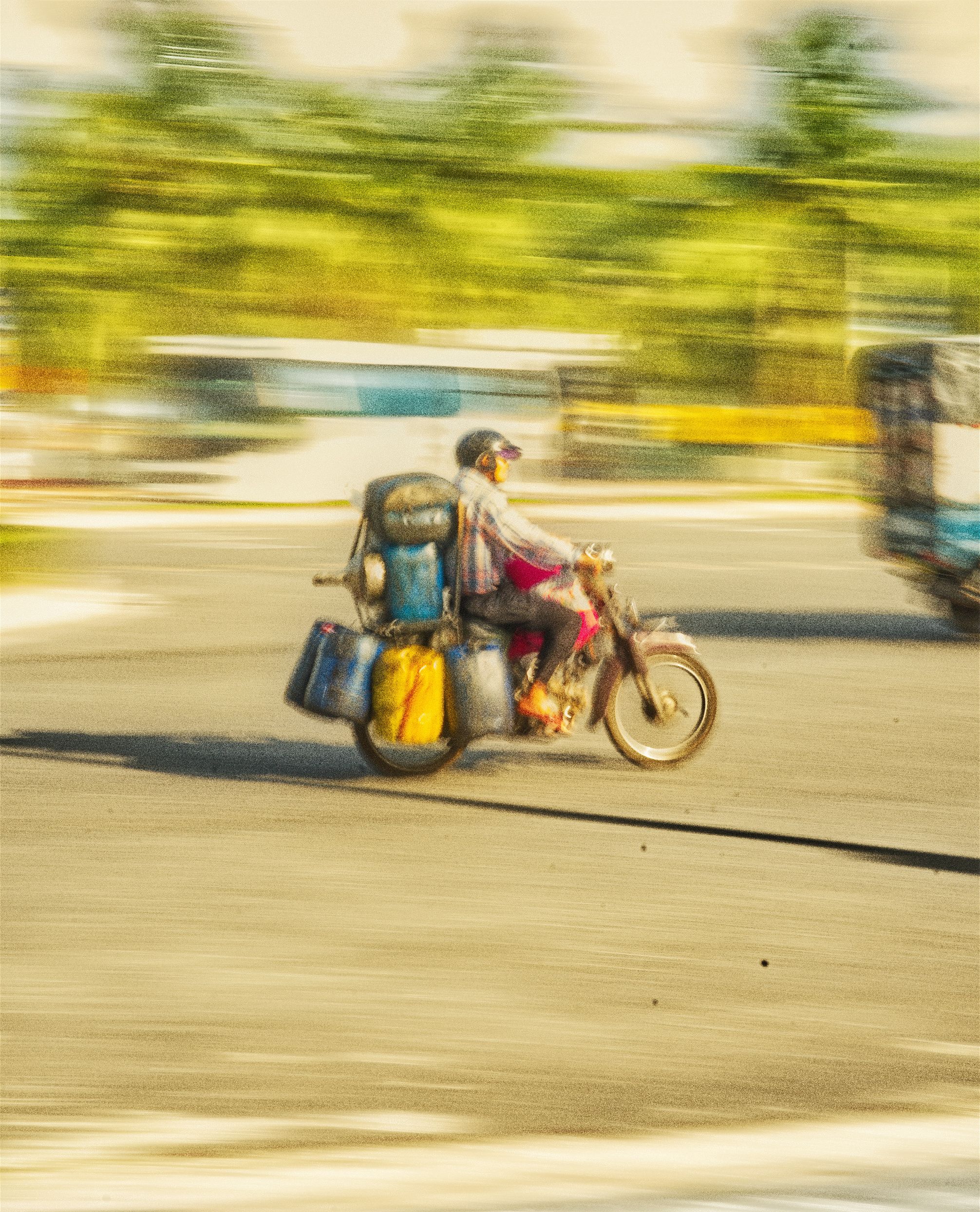 Vietnam — loaded motorbike, panning shot